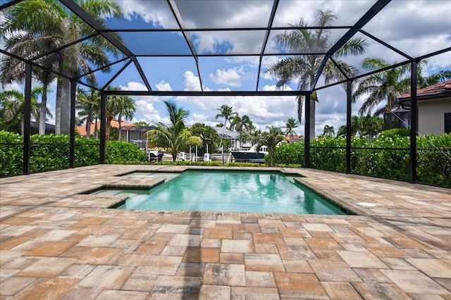 3800 Carupano Ct, Punta Gorda, FL 33950 - outdoor pool featuring a patio, glass enclosure, and a hot tub