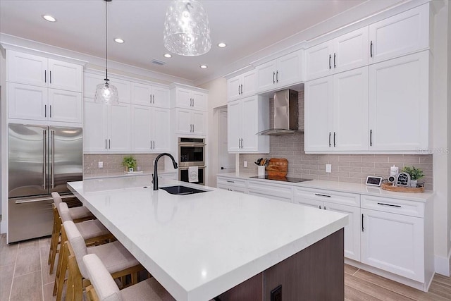 3800 Carupano Ct, Punta Gorda, FL 33950 - kitchen with appliances with stainless steel finishes, wall chimney exhaust hood, white cabinetry, light countertops, and recessed lighting