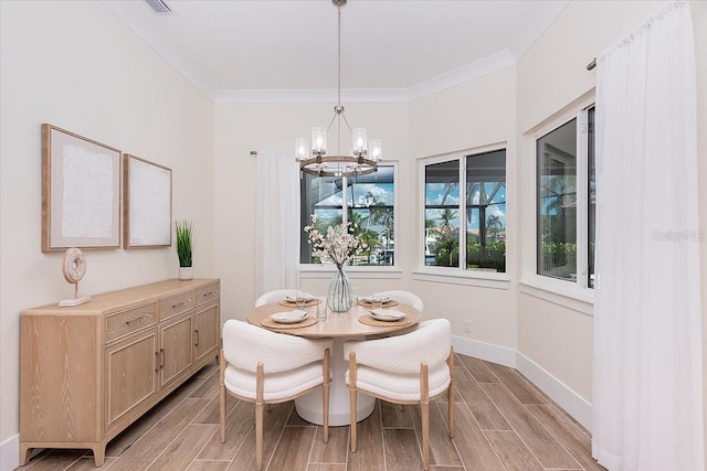 3800 Carupano Ct, Punta Gorda, FL 33950 - dining space featuring a chandelier, wood finish floors, and ornamental molding