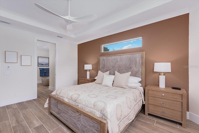 3800 Carupano Ct, Punta Gorda, FL 33950 - bedroom featuring wood finish floors, a raised ceiling, and ensuite bathroom