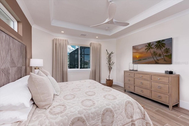 3800 Carupano Ct, Punta Gorda, FL 33950 - bedroom with a raised ceiling, multiple windows, light wood-type flooring, crown molding, and recessed lighting