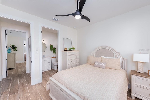 3800 Carupano Ct, Punta Gorda, FL 33950 - bedroom with light wood finished floors, ensuite bathroom, and ceiling fan