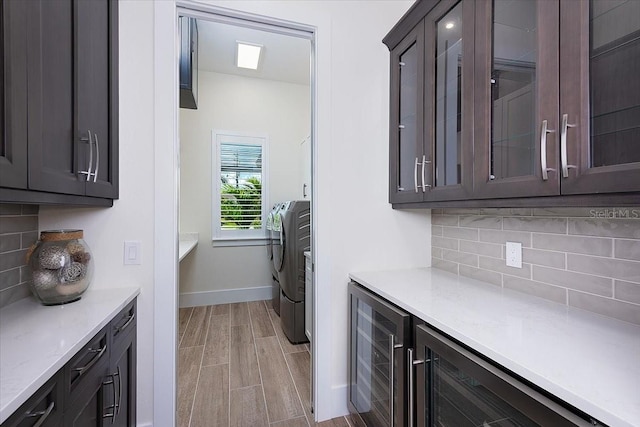 3800 Carupano Ct, Punta Gorda, FL 33950 - laundry room featuring beverage cooler, washing machine and dryer, and light wood finished floors