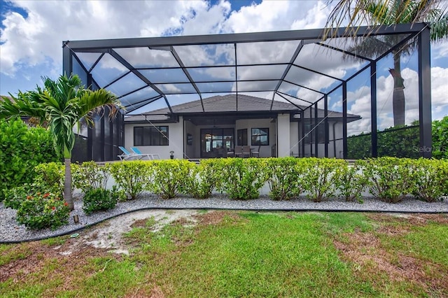 3800 Carupano Ct, Punta Gorda, FL 33950 - back of house featuring glass enclosure, stucco siding, and a shingled roof
