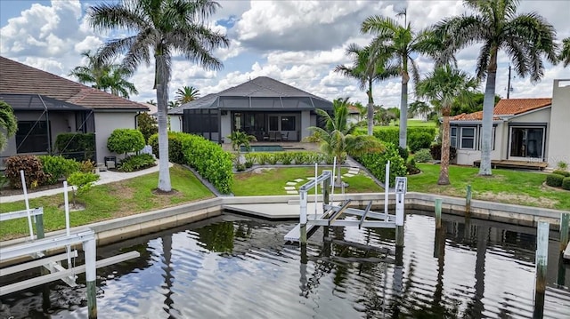 3800 Carupano Ct, Punta Gorda, FL 33950 - dock with boat lift, a water view, a lawn, and glass enclosure