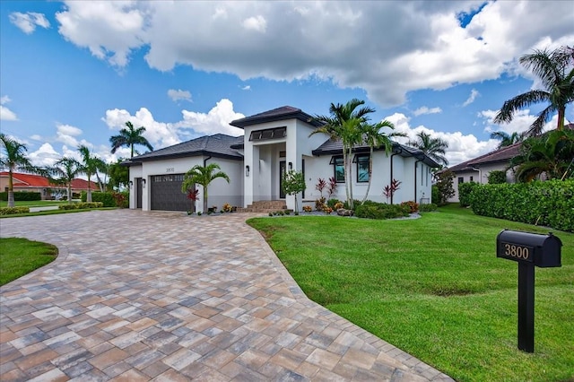 3800 Carupano Ct, Punta Gorda, FL 33950 - view of front of property featuring a garage, stucco siding, decorative driveway, and a front yard