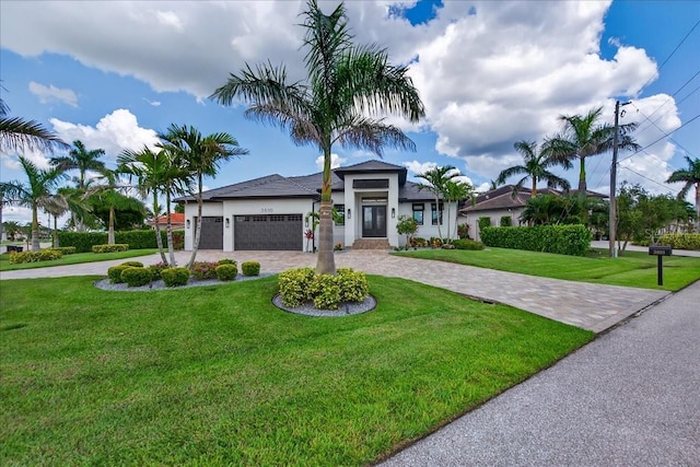 3800 Carupano Ct, Punta Gorda, FL 33950 - view of front facade with curved driveway, a front lawn, an attached garage, and stucco siding
