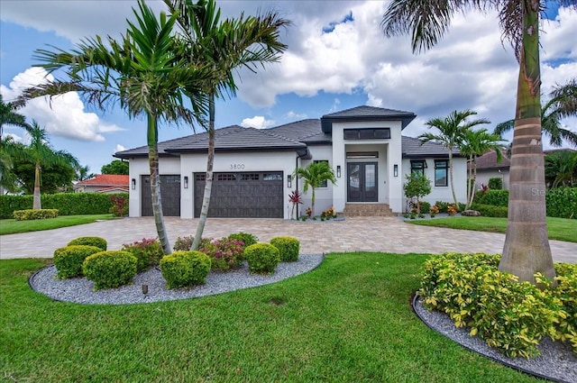 3800 Carupano Ct, Punta Gorda, FL 33950 - prairie-style home featuring french doors, stucco siding, a front yard, and curved driveway
