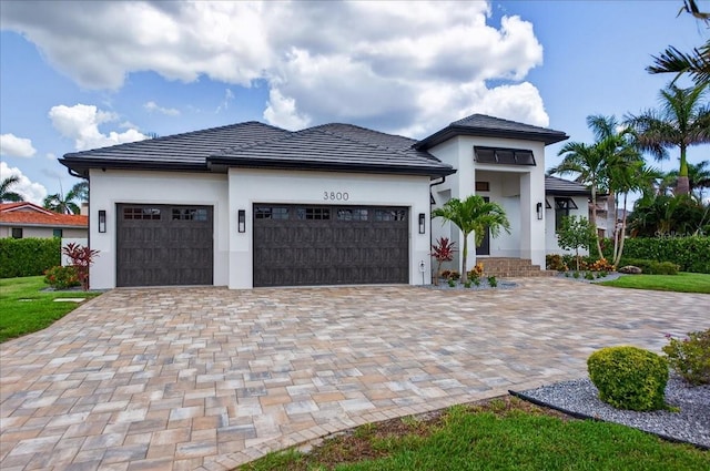 3800 Carupano Ct, Punta Gorda, FL 33950 - view of front facade featuring an attached garage, stucco siding, and decorative driveway