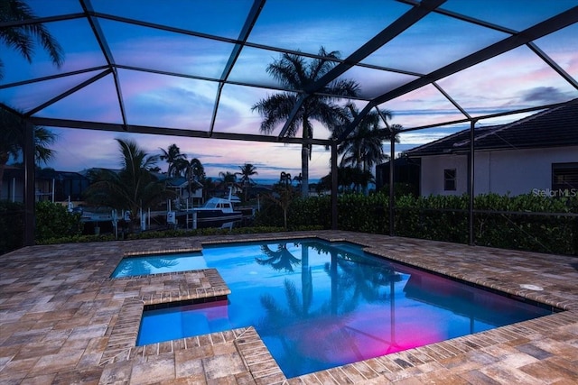 3800 Carupano Ct, Punta Gorda, FL 33950 - pool at dusk featuring a patio area, an outdoor pool, and an in-ground hot tub