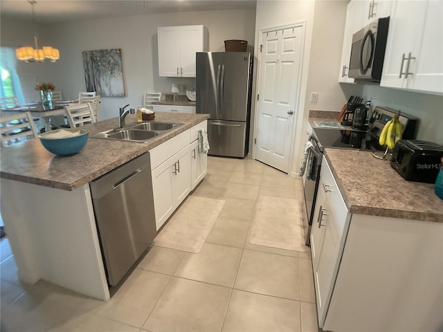 25228 E Lenox Cir, Punta Gorda, FL 33950 - kitchen with appliances with stainless steel finishes, white cabinetry, a kitchen island with sink, and light tile patterned floors