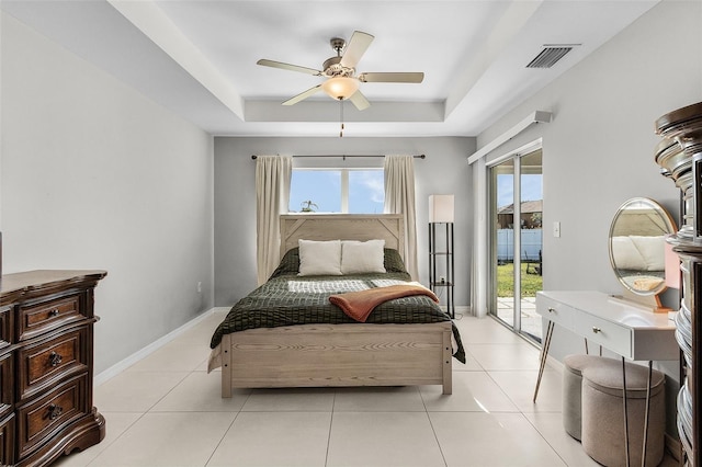 1731 NW 24th Pl, Cape Coral, FL 33993 - bedroom featuring a tray ceiling, access to outside, a ceiling fan, and light tile patterned flooring