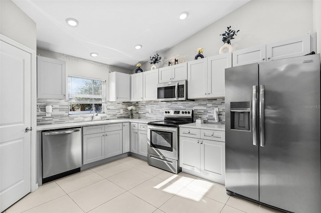 1731 NW 24th Pl, Cape Coral, FL 33993 - kitchen featuring stainless steel appliances, backsplash, light countertops, and recessed lighting