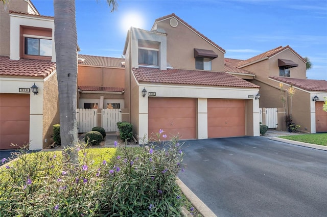 7150 Golden Eagle Ct Unit 213, Fort Myers, FL 33912 - multi unit property with a tile roof, stucco siding, asphalt driveway, and a gate