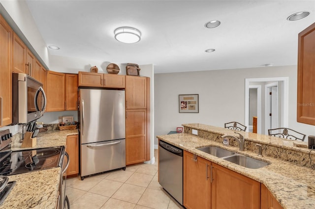 7150 Golden Eagle Ct Unit 213, Fort Myers, FL 33912 - kitchen with stainless steel appliances, light stone counters, recessed lighting, light tile patterned floors, and brown cabinetry