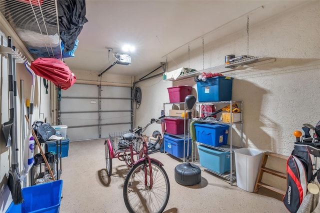 7150 Golden Eagle Ct Unit 213, Fort Myers, FL 33912 - garage featuring a garage door opener and a textured wall