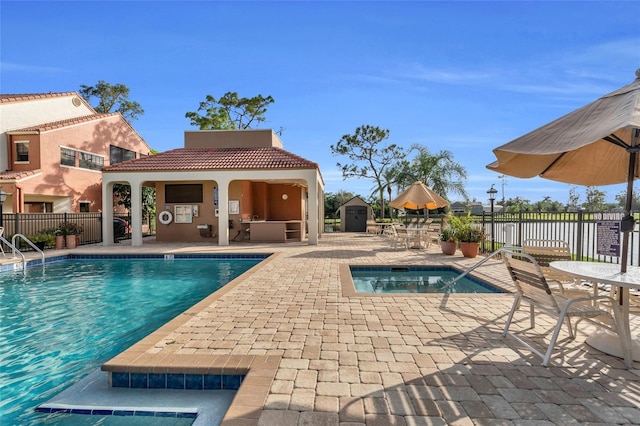 7150 Golden Eagle Ct Unit 213, Fort Myers, FL 33912 - community pool with a patio area, a gazebo, a storage unit, and a hot tub
