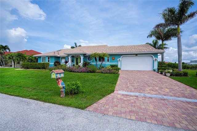1418 Grebe Dr, Punta Gorda, FL 33950 - ranch-style house featuring decorative driveway, a garage, a front lawn, and stucco siding