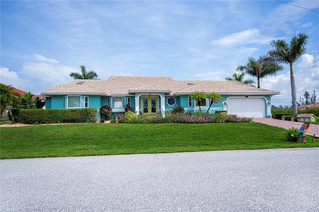 1418 Grebe Dr, Punta Gorda, FL 33950 - ranch-style house with a garage, driveway, and a front yard