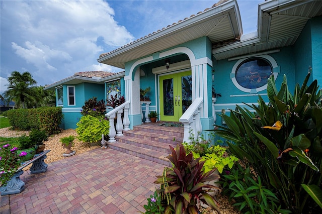 1418 Grebe Dr, Punta Gorda, FL 33950 - doorway to property with french doors, stucco siding, and a tiled roof