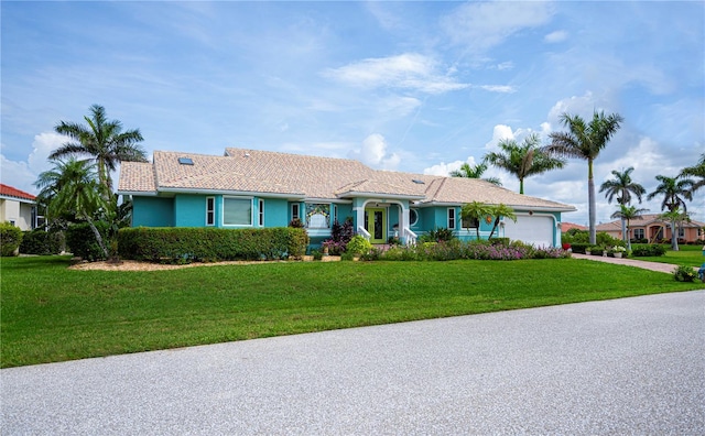 1418 Grebe Dr, Punta Gorda, FL 33950 - ranch-style house featuring a garage, a front lawn, concrete driveway, and stucco siding