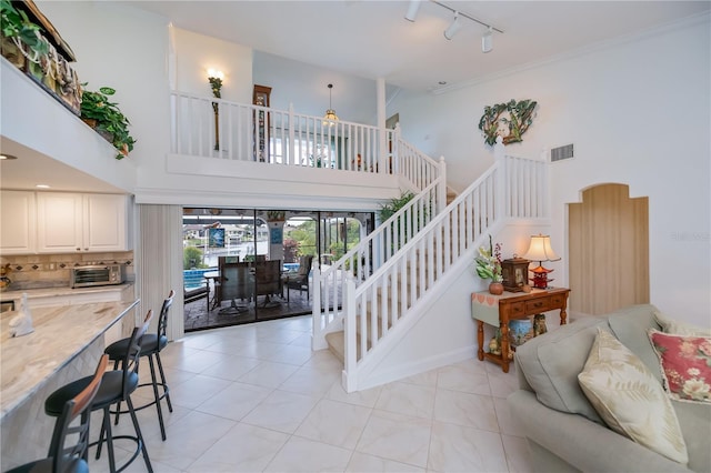 1418 Grebe Dr, Punta Gorda, FL 33950 - stairs with track lighting, a towering ceiling, and ceiling fan