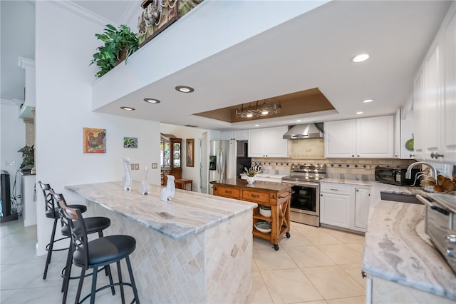 1418 Grebe Dr, Punta Gorda, FL 33950 - kitchen with appliances with stainless steel finishes, wall chimney range hood, light stone counters, white cabinetry, and recessed lighting