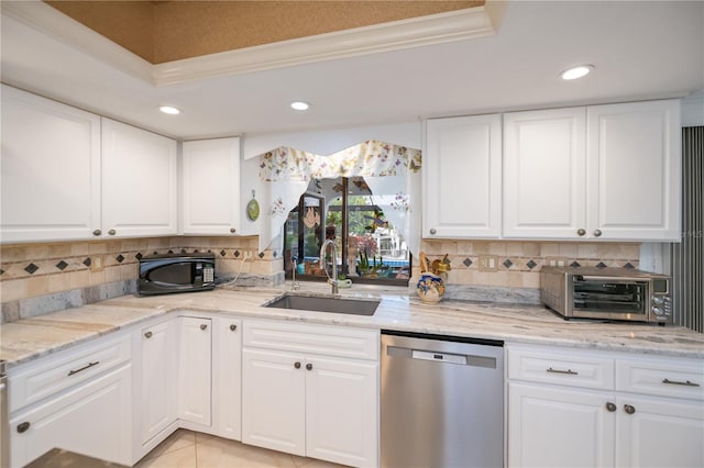 1418 Grebe Dr, Punta Gorda, FL 33950 - kitchen with stainless steel dishwasher, black microwave, recessed lighting, backsplash, and white cabinetry