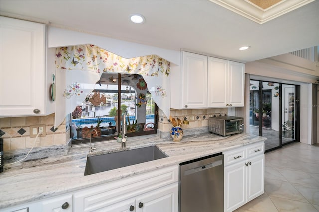 1418 Grebe Dr, Punta Gorda, FL 33950 - kitchen with stainless steel dishwasher, decorative backsplash, recessed lighting, white cabinets, and ornamental molding