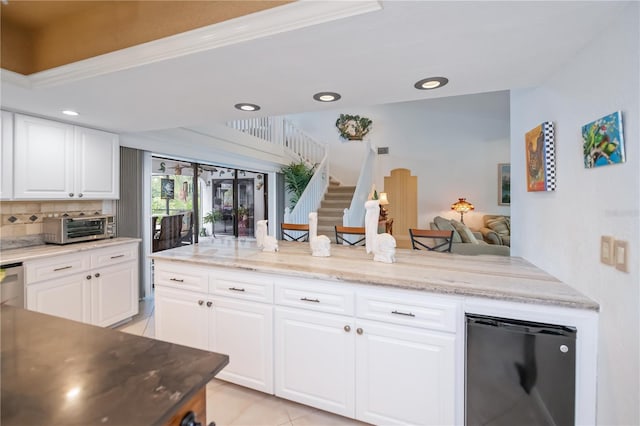 1418 Grebe Dr, Punta Gorda, FL 33950 - kitchen with fridge, tasteful backsplash, white cabinets, recessed lighting, and light tile patterned floors