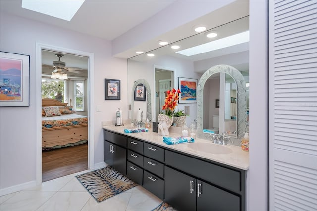 1418 Grebe Dr, Punta Gorda, FL 33950 - full bathroom featuring a skylight, ensuite bathroom, double vanity, tile patterned floors, and a closet