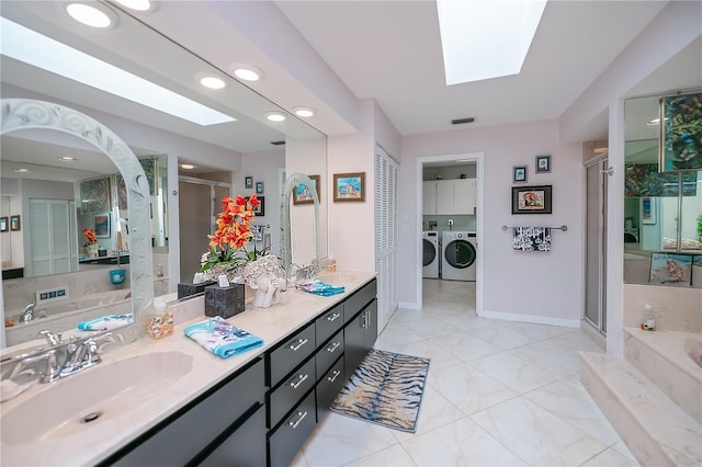 1418 Grebe Dr, Punta Gorda, FL 33950 - bathroom featuring a skylight, washing machine and dryer, a stall shower, and recessed lighting
