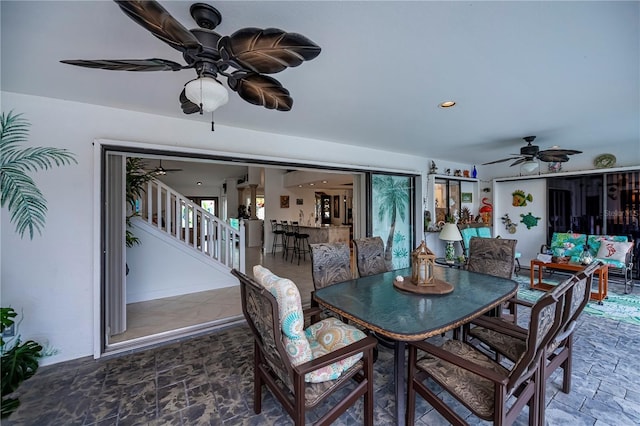 1418 Grebe Dr, Punta Gorda, FL 33950 - dining space featuring ceiling fan, stone finish flooring, and stairway