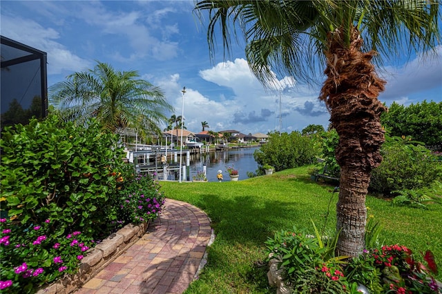 1418 Grebe Dr, Punta Gorda, FL 33950 - dock area with boat lift, a lawn, and a water view