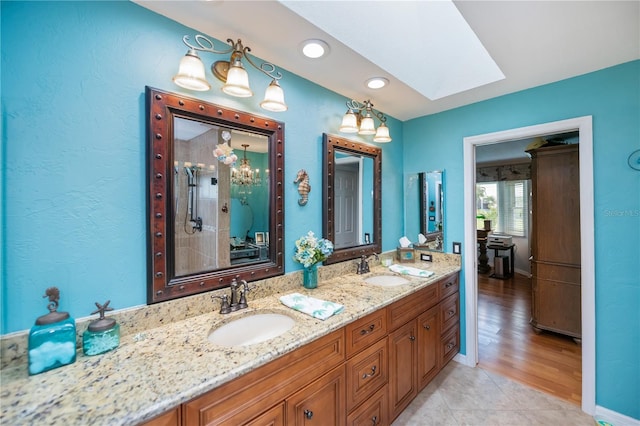 1418 Grebe Dr, Punta Gorda, FL 33950 - full bath with a skylight, double vanity, a shower stall, recessed lighting, and tile patterned floors