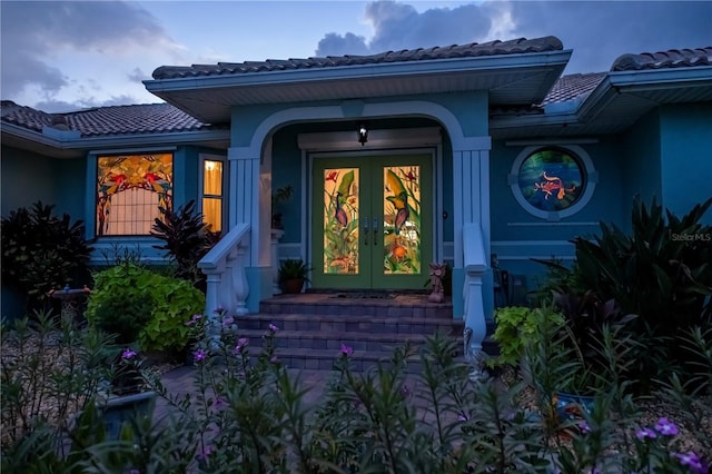 1418 Grebe Dr, Punta Gorda, FL 33950 - doorway to property featuring a tiled roof, french doors, and stucco siding