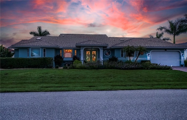 1418 Grebe Dr, Punta Gorda, FL 33950 - single story home featuring a tile roof, a front lawn, a garage, driveway, and stucco siding