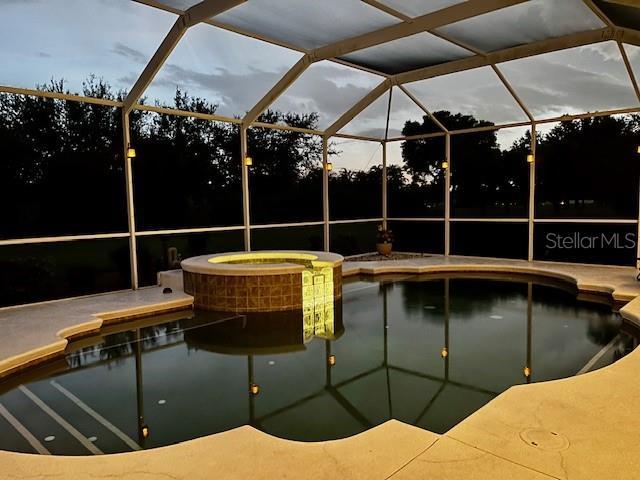 260 Rotonda Blvd E, Rotonda West, FL 33947 - view of pool featuring a pool with connected hot tub, a lanai, and a patio
