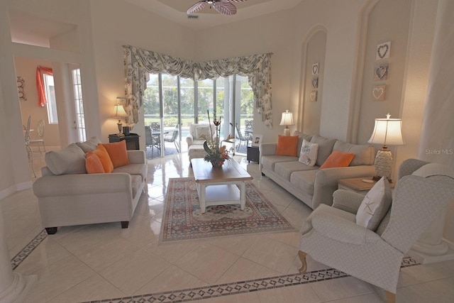 260 Rotonda Blvd E, Rotonda West, FL 33947 - living room with tile patterned flooring, a ceiling fan, and arched walkways