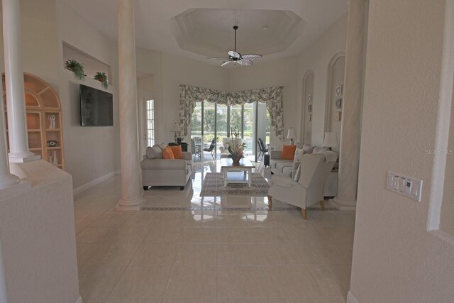 260 Rotonda Blvd E, Rotonda West, FL 33947 - living area with ornate columns, tile patterned flooring, a ceiling fan, and a tray ceiling
