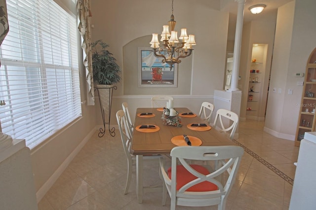 260 Rotonda Blvd E, Rotonda West, FL 33947 - dining area featuring light tile patterned flooring, built in shelves, decorative columns, and a chandelier