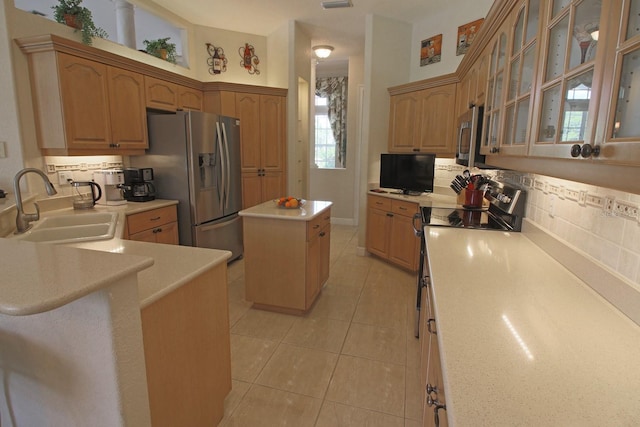 260 Rotonda Blvd E, Rotonda West, FL 33947 - kitchen featuring appliances with stainless steel finishes, tasteful backsplash, light tile patterned floors, light countertops, and glass insert cabinets