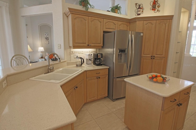 260 Rotonda Blvd E, Rotonda West, FL 33947 - kitchen with stainless steel fridge, light tile patterned flooring, light countertops, and a center island