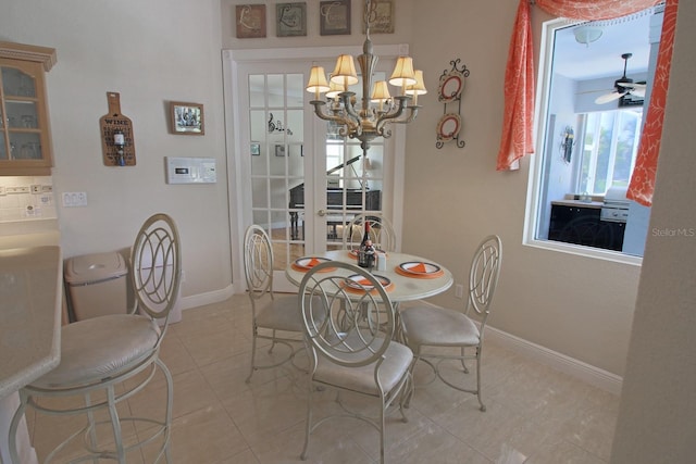 260 Rotonda Blvd E, Rotonda West, FL 33947 - dining room with a chandelier, light tile patterned floors, and a ceiling fan