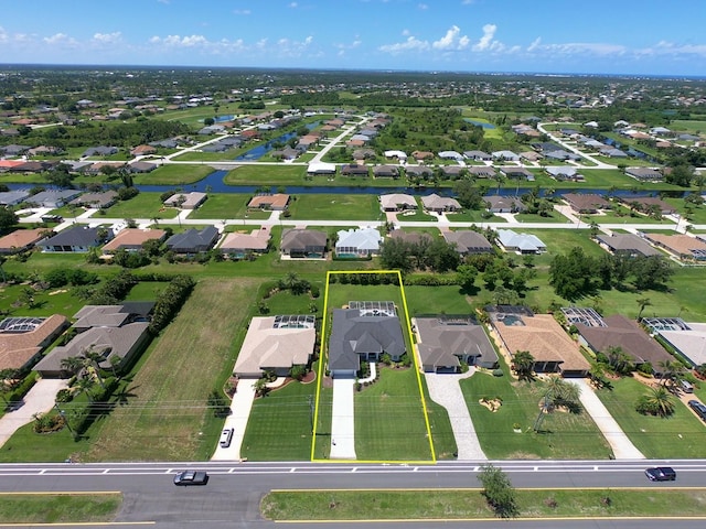 260 Rotonda Blvd E, Rotonda West, FL 33947 - aerial view of property and surrounding area featuring nearby suburban area, property parcel outlined, and a nearby body of water