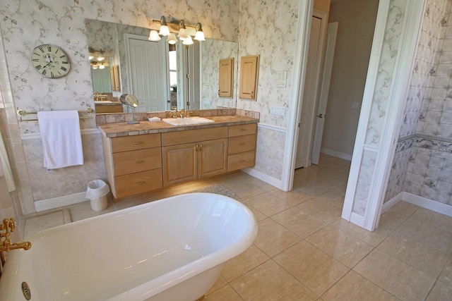 260 Rotonda Blvd E, Rotonda West, FL 33947 - bathroom featuring wallpapered walls, a freestanding tub, vanity, and tile patterned flooring