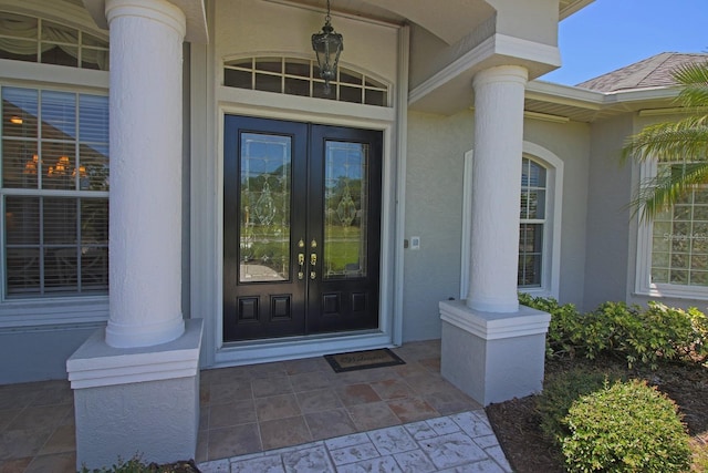 260 Rotonda Blvd E, Rotonda West, FL 33947 - property entrance with french doors and stucco siding