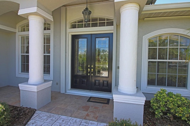260 Rotonda Blvd E, Rotonda West, FL 33947 - doorway to property with french doors and stucco siding