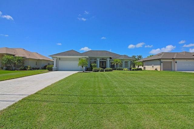 260 Rotonda Blvd E, Rotonda West, FL 33947 - single story home featuring a garage, driveway, a front yard, and stucco siding