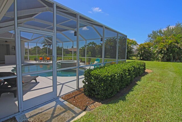 260 Rotonda Blvd E, Rotonda West, FL 33947 - outdoor pool featuring a jacuzzi, a yard, a patio, and a lanai